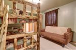 Copper Claim Lodge bedroom with log bunk beds. 